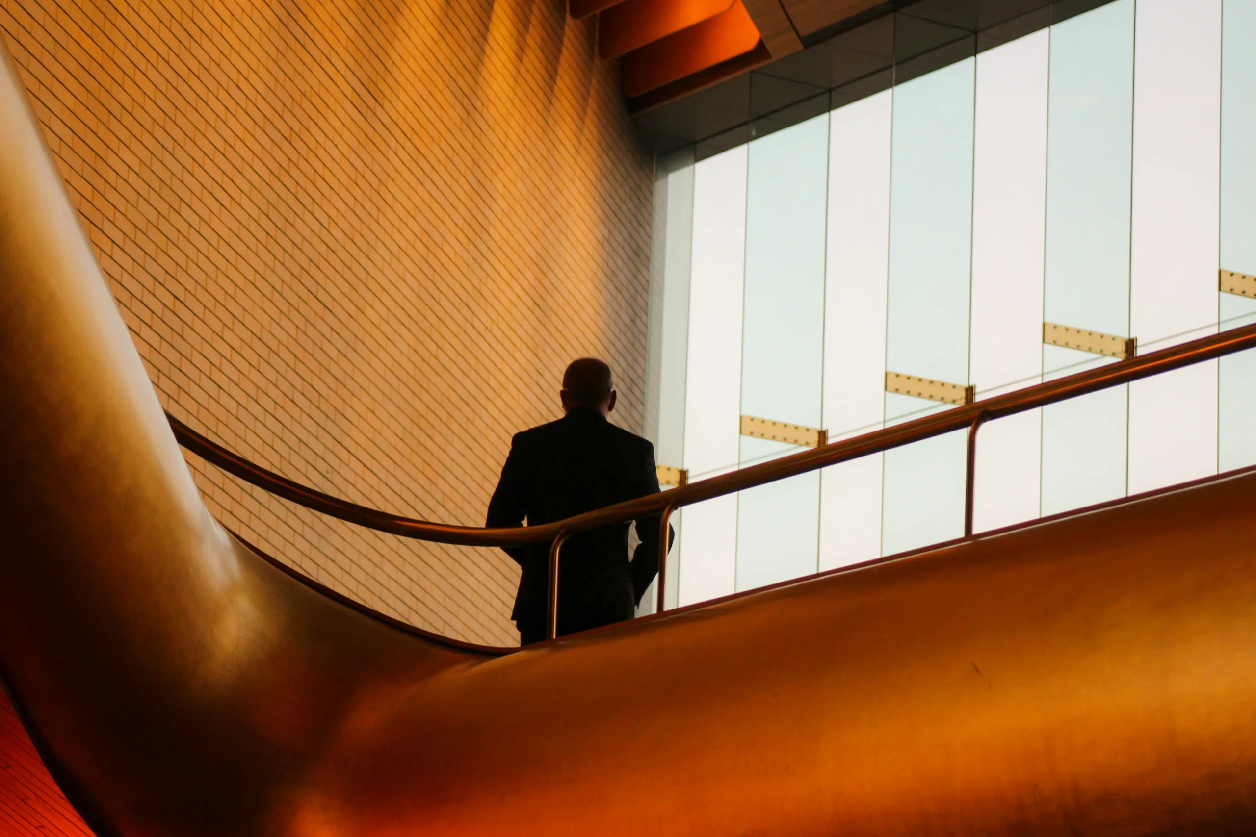 Founder on a stairway in a sunlit atrium