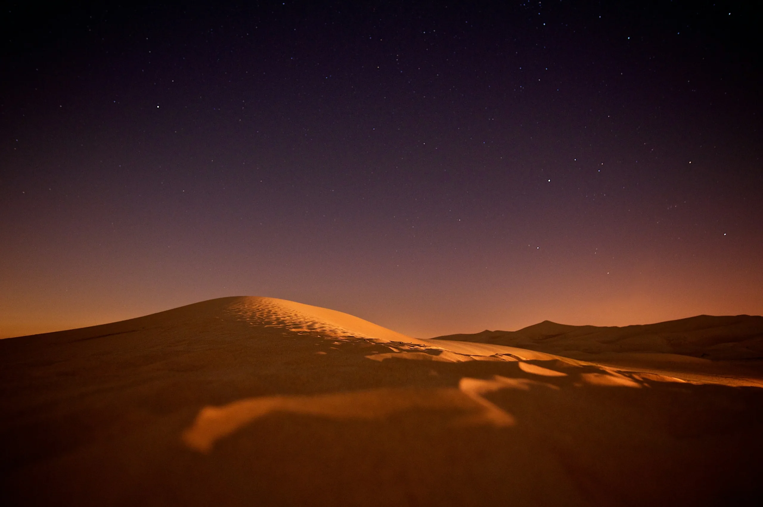 Desert dunes under a starry sky